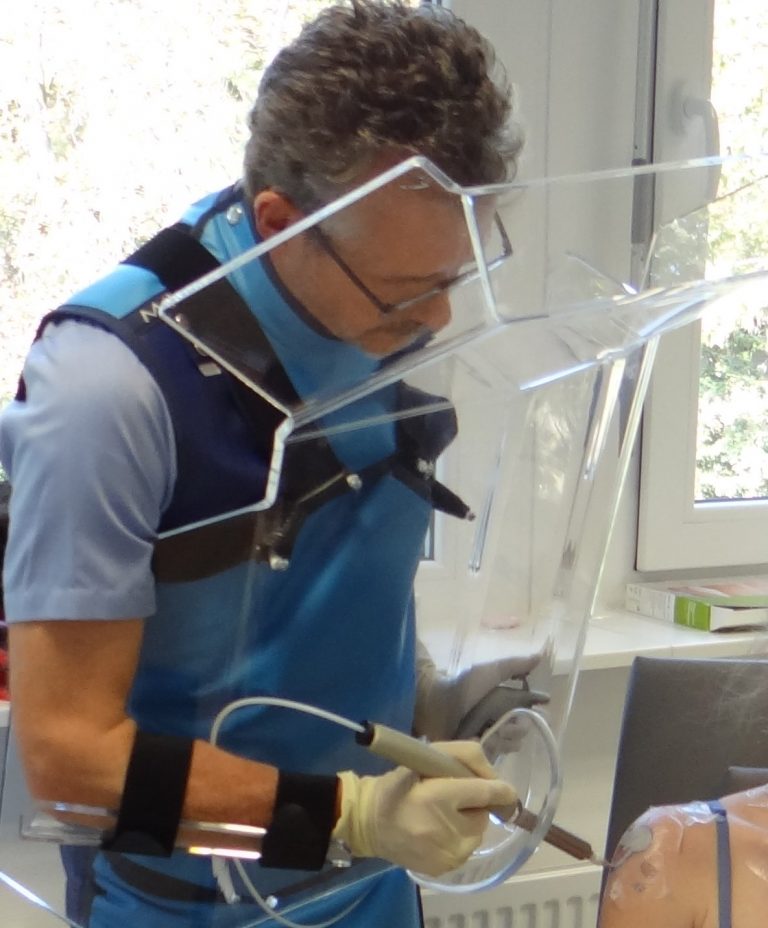 Doctor using the OncoBeta Applicator and protective gear